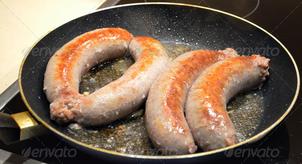 Hose packed meat baking pan. Fatty pork sausages - Stock Photo - Images