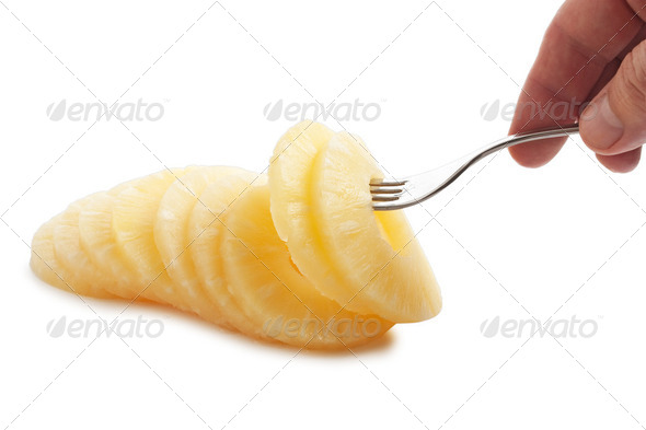 slice of pineapple on a fork - Stock Photo - Images