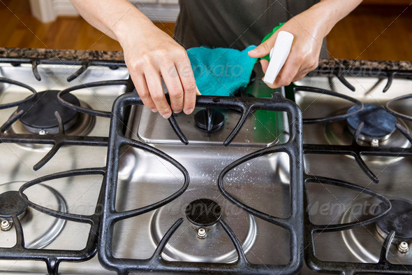 Spraying down Stove Top Range for Cleaning - Stock Photo - Images