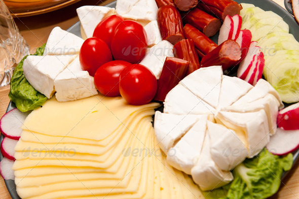 platter of cold cuts cheese and sausages with ham and tomatoes - Stock Photo - Images