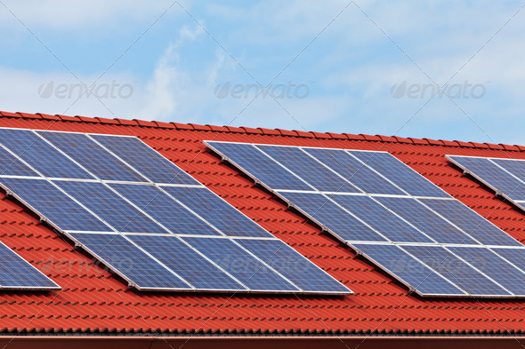 Solar panels on the roof of a row of houses - Stock Photo - Images