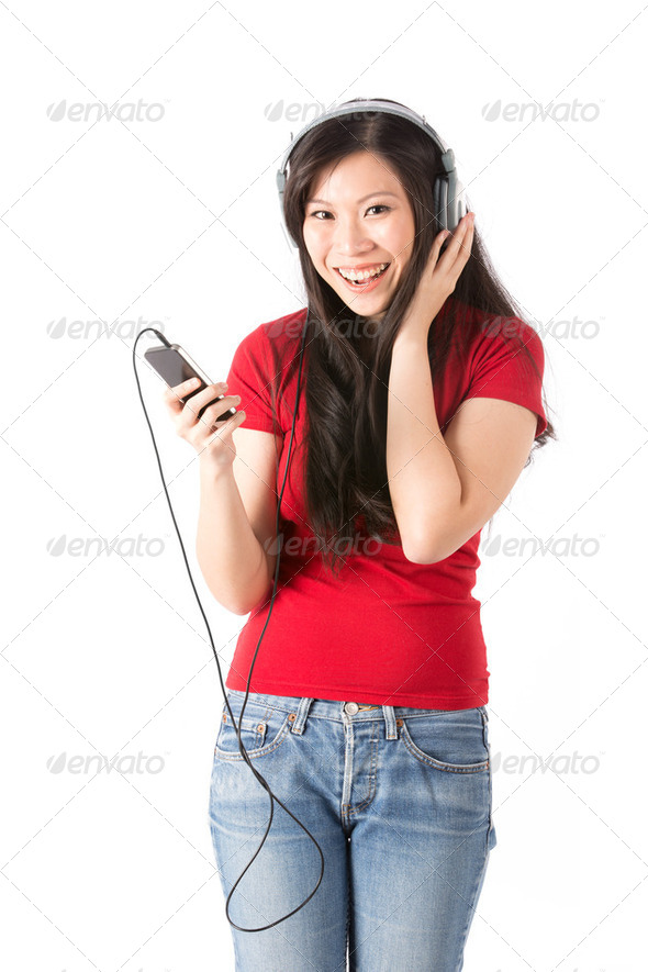 Happy Asian woman listening to Music - Stock Photo - Images