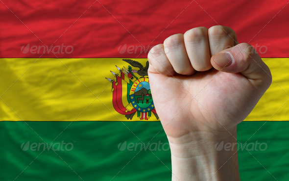 Hard fist in front of bolivia flag symbolizing power - Stock Photo - Images
