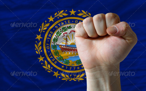 us state flag of new hampshire with hard fist in front of it sym - Stock Photo - Images