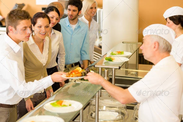 Office colleagues in canteen cook serve meals - Stock Photo - Images
