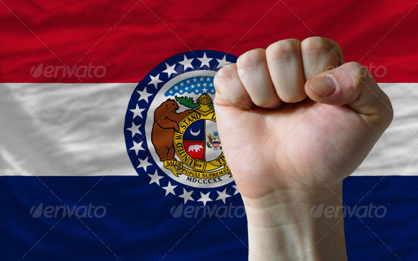 us state flag of missouri with hard fist in front of it symboliz - Stock Photo - Images