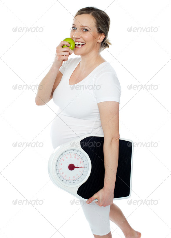 Young pregnant woman enjoy fresh green apple - Stock Photo - Images