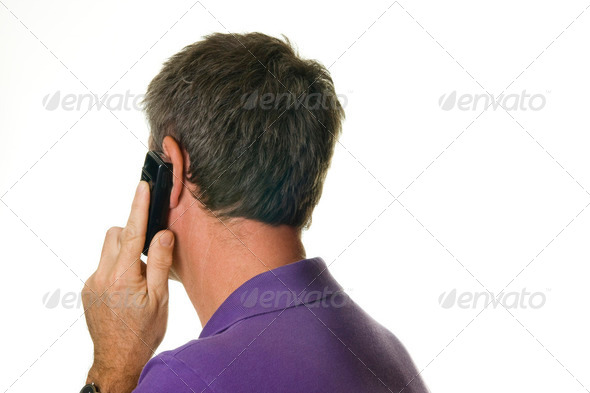 Man listening to cell phone. Seen on the back - Stock Photo - Images