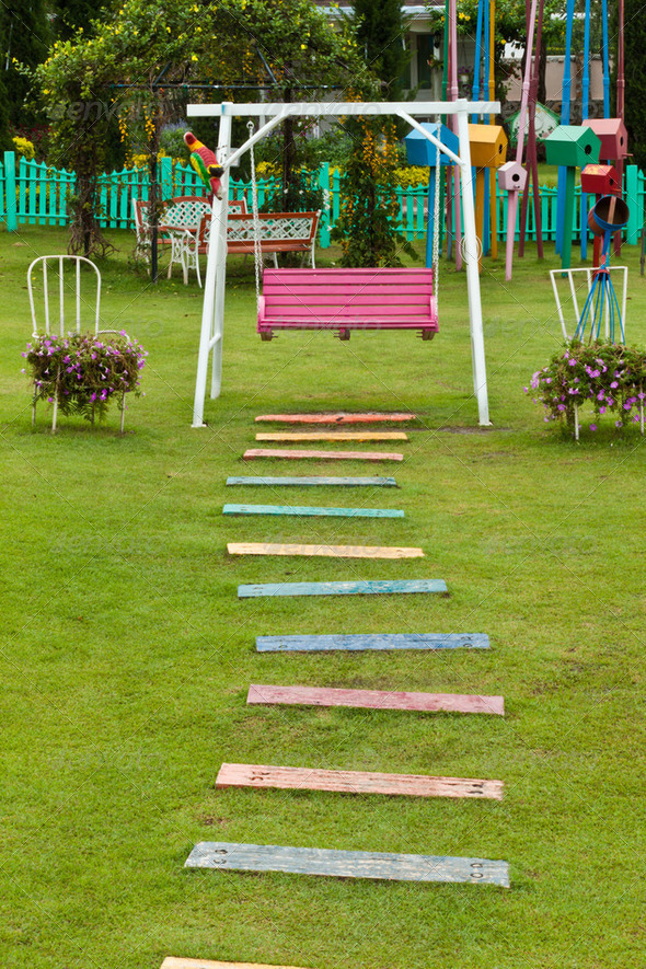 garden stone path with grass growing up between the stones - Stock Photo - Images