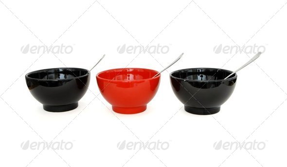 Row of two black and one red porcelain bowls with spoons isolated - Stock Photo - Images