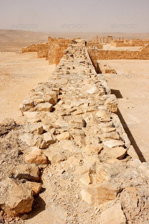 Wall of the ancient fortress in the desert during sandstorm - Stock Photo - Images