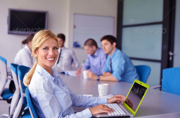business woman with her staff in background at office - Stock Photo - Images