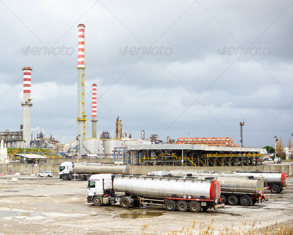 Oil refinery industry, smoke stacks and tanker lorry or truck