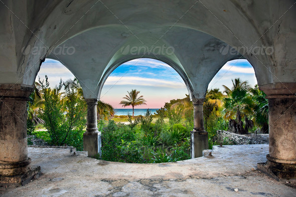 A beautiful view of the ocean from inside an old abandoned mansion.