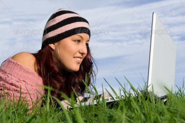 teen outdoor on internet with wifi laptop computer