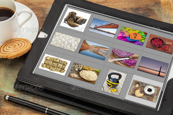 viewing pictures on digital tablet - Stock Photo - Images