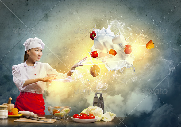 Asian female cooking with magic - Stock Photo - Images