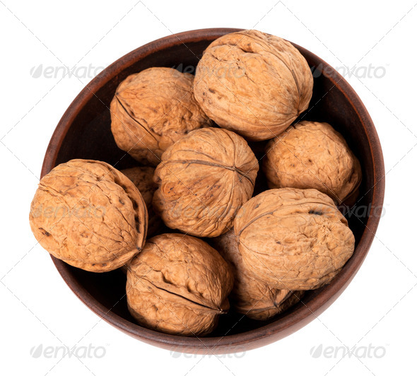 Walnuts in ceramic bowl. Top view. - Stock Photo - Images
