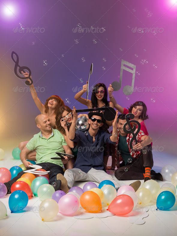 group of friends with musical notes and balloons - Stock Photo - Images