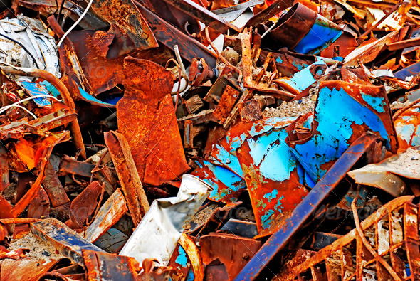 Big rusty iron pile outdoors on a junkyard ready for recycling