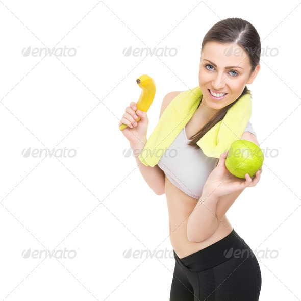 Happy fit young woman holding healthy fruits - Stock Photo - Images