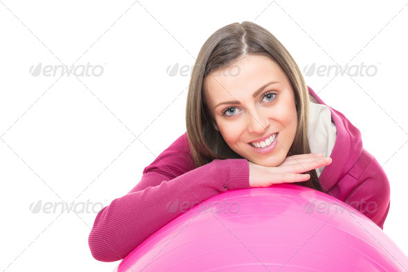 Happy young woman with pink fitness ball - Stock Photo - Images