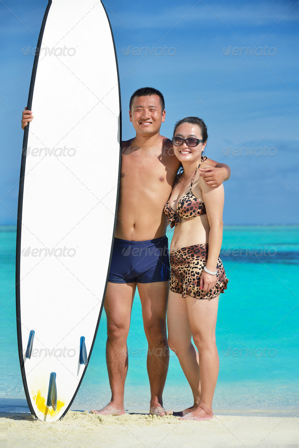happy young couple enjoying summer on beach - Stock Photo - Images