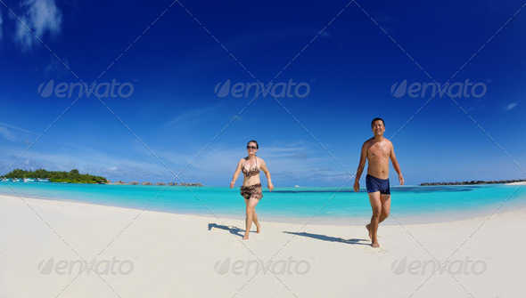 happy young couple enjoying summer on beach - Stock Photo - Images