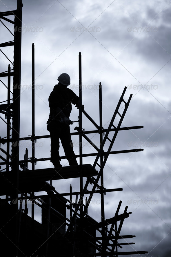 builder on scaffolding building site - Stock Photo - Images