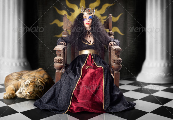 Fashion queen in crown sitting in jester court - Stock Photo - Images