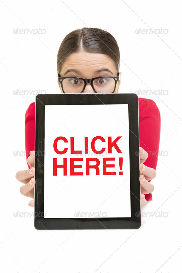 Surprised businesswoman showing digital tablet screen that states click here - Stock Photo - Images