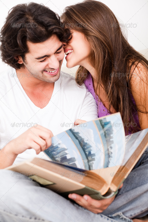 Cute Couple Embracing with Photo Album - Stock Photo - Images