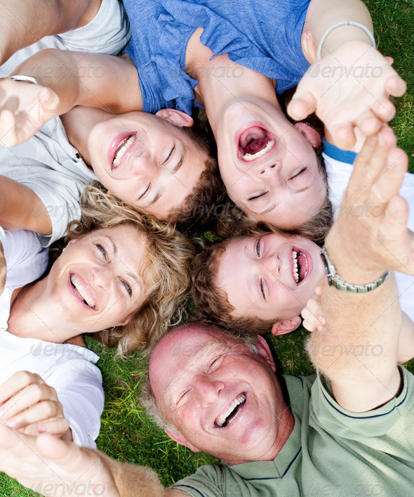 Multi-generation family lying in circle - Stock Photo - Images