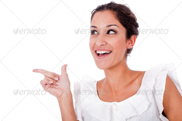 Close up portrait of a happy young woman pointing up at copyspace - Stock Photo - Images
