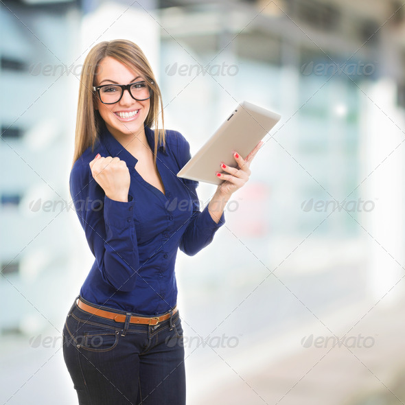 Happy young businesswoman with tablet computer - Stock Photo - Images