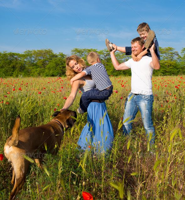 Family playing on the meadow