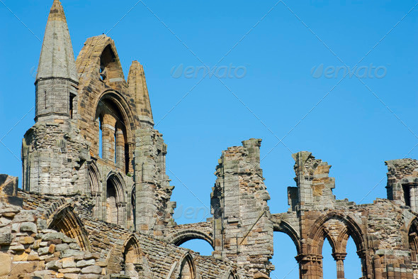 Close-up of the Whitby Abbey gothic ruins with the top of the facade and nave column during a sunny day. Whitby, North Yorkshire, England, United Kingdom, Europe