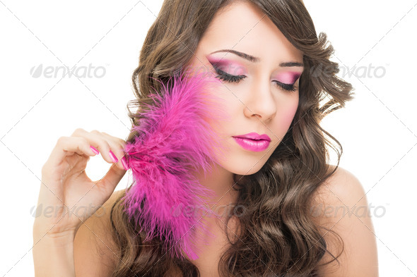 Glamorous young woman with pink feather - Stock Photo - Images