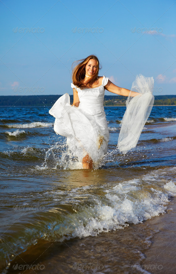 bride running in waves - Stock Photo - Images