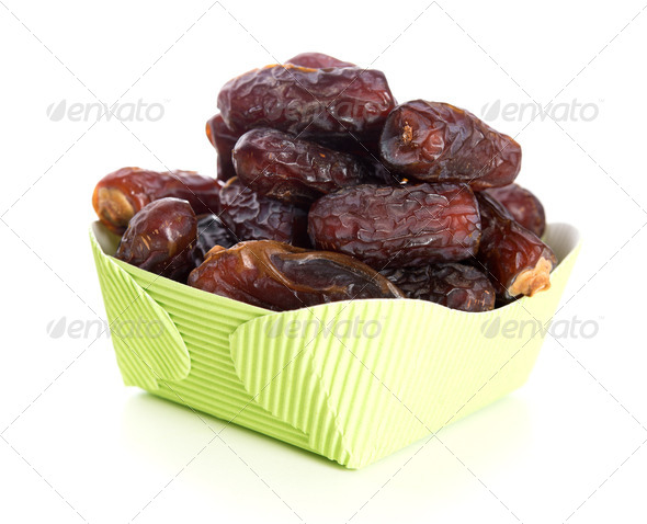 Kurma dried date palm fruits, ramadan food which eaten in fasting month. Pile of fresh dried date fruits in paper box.
