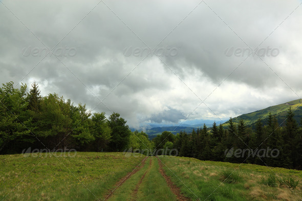 Mountain landscape. Pathway and storm clouds in the mountains.