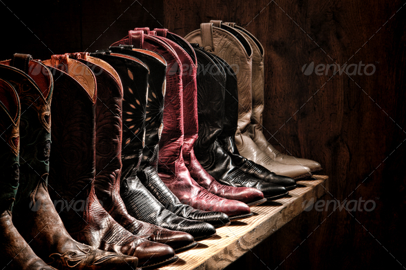 American West rodeo fancy cowgirl leather boots collection on old wood shelf in a western fashion aficionado girl ranch closet