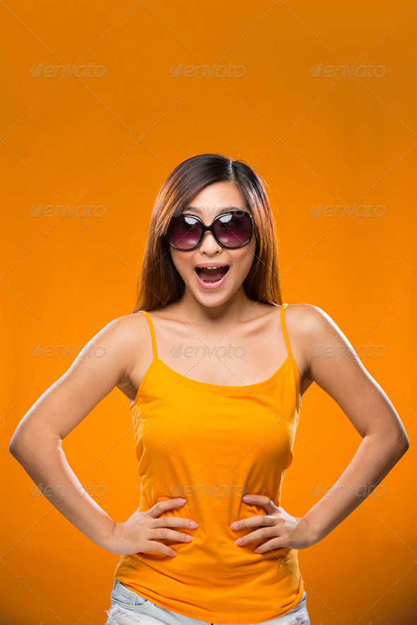 Young happy Chinese female model on colorful background.