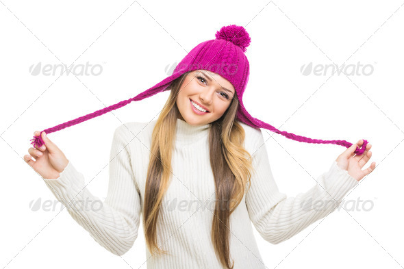 Beautiful teenage girl wearing pink winter hat and white jumper - Stock Photo - Images