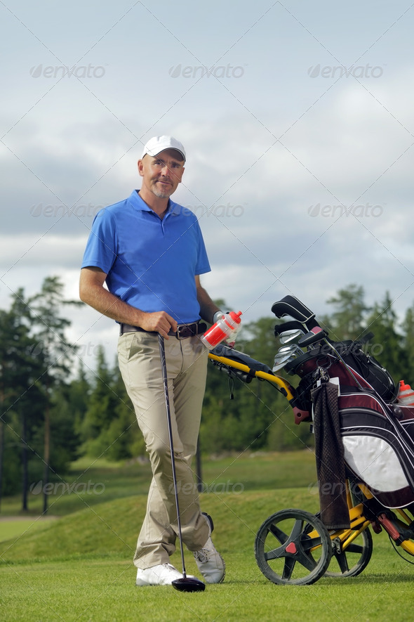 Man standing by golf bag full of sticks (Misc) Photo Download