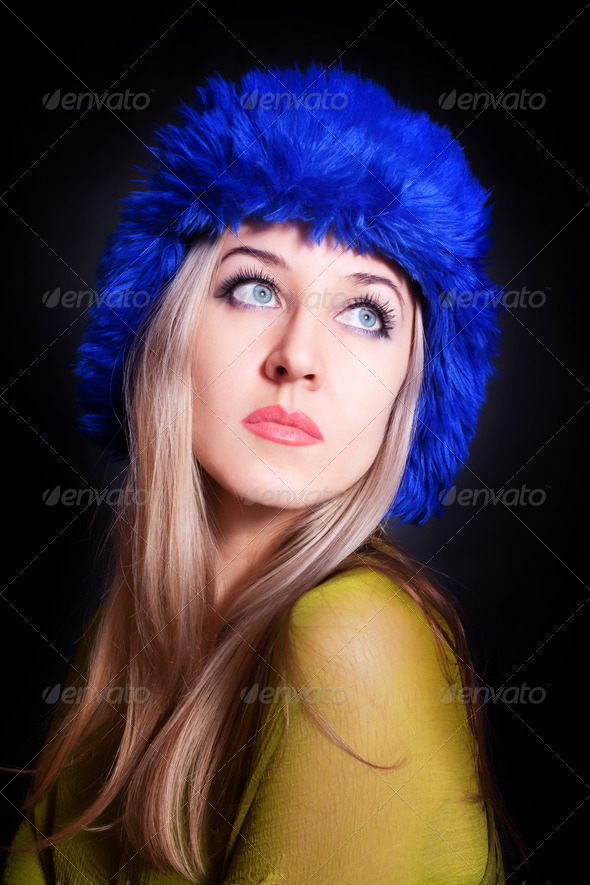 beautiful young woman in blue winter hat - Stock Photo - Images