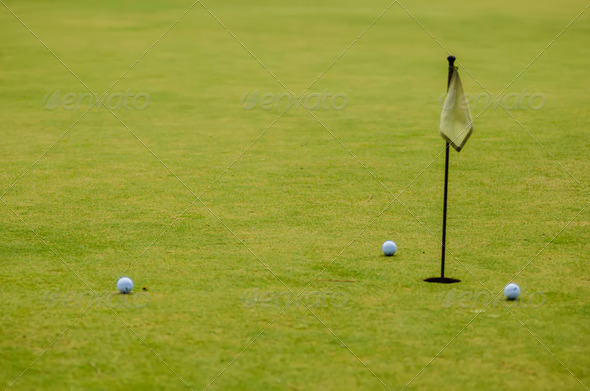 Golf ball on a green, in front of the hole, - Stock Photo - Images