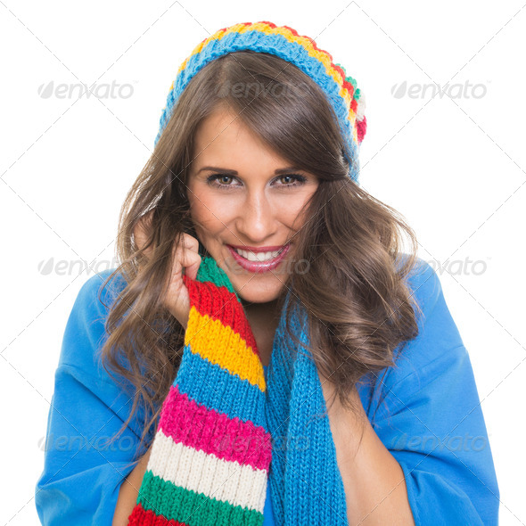 Beautiful young woman wearing colorful winter hat and scarf smiling - Stock Photo - Images