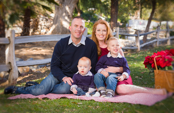 Beautiful Small Young Family Holiday Portrait in the Park.