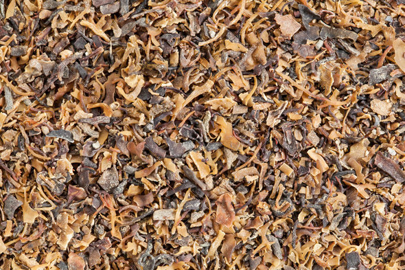 Background of dried Irish moss seaweed (Chondrus crispus) rich in iodine. It is harvested to make carrageenan, a thickening agent for jellies, puddings, and soups, and is a traditional herbal remedy in Ireland.